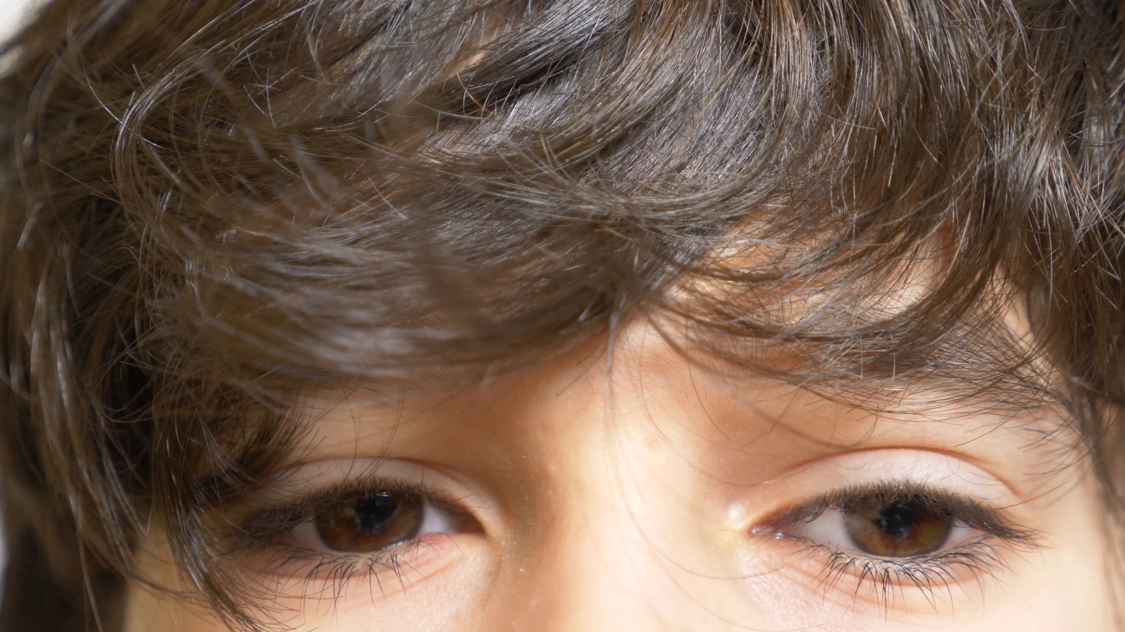 The brown eyes of a boy with long black ... | Stock Video | Pond5