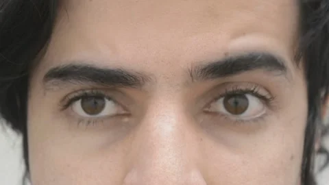 Brown eyes looking at camera, blinking and looking at different sides Stock Footage 151984820