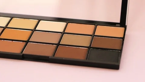 Brown Eyeshadows Palette on the pink background Stock Footage 116206928