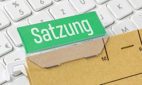 A brown file folder labeled Statutes in german - Satzung Stock Photos