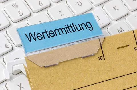A brown file folder labeled with Valuation in german - Wertermittlung. 库存照片