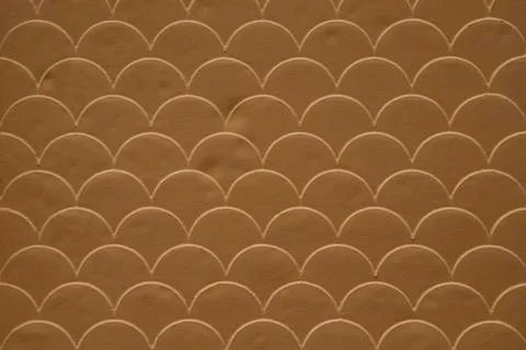 Brown fish scale seamless pattern on decorated cement wall Stock Photos