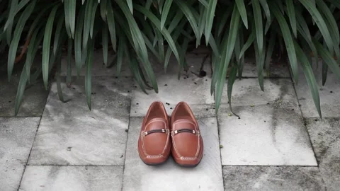 Brown flat shoes on the wall 스톡 동영상 140239540
