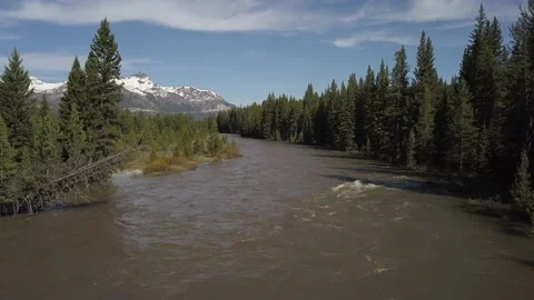 Brown flooded mountain river with tall peak Stock Footage 166323856