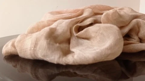 A brown flowered clothes on a table Stock Footage 146257397