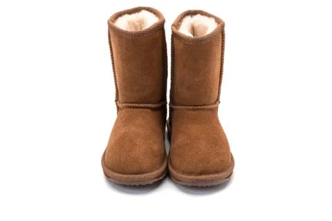 Brown fluffy ugg boot style childrens footwear on white background Stock Photos