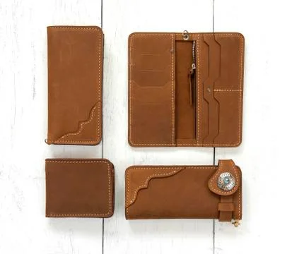Brown genuine leather wallets accessory isolated on wooden background. Top vi Stock Photos
