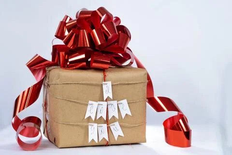 Brown gift box with red bow, "I love you" lettering, white background Stock Photos