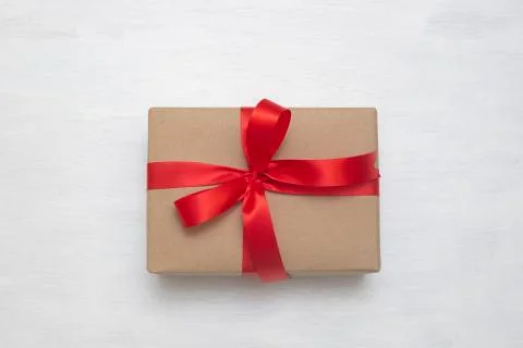 Brown gift box with red ribbon isolated on white background Stock Photos