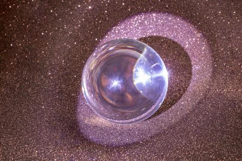 Brown glitter reflections and light circle thru a lens ball, on deep blue d.. Foto stock