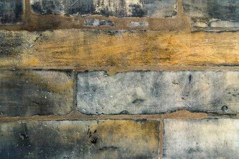 Brown-gray art background from the texture wall of an ancient building made o Stock Photos