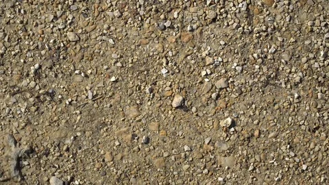 Brown ground texture with small stones in motion Stock Footage 89580415