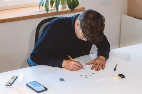 Brown-haired architect creates new product designs for a new futuristic world Stock Photos