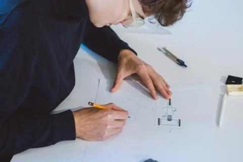 Brown-haired architect is thinking hard about how to create new product desig Stock Photos