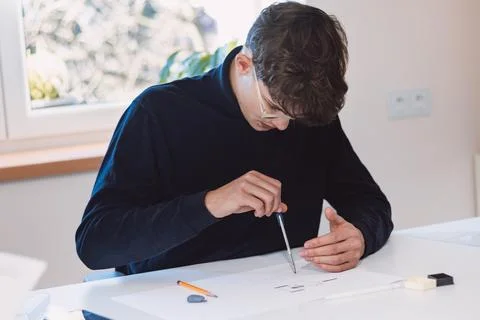Brown-haired architect is thinking hard about how to create new product desig Stock Photos