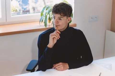 Brown-haired architect is thinking hard about how to create new product desig Stock Photos