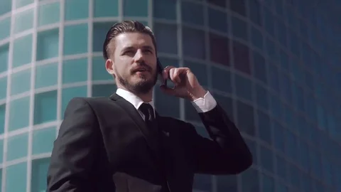 Brown-haired business man talking on the phone outdoors Stock-Footage 69166016