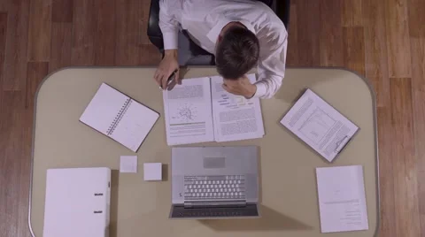 Brown-haired businessman checking the text of his document Stock-Footage 68713312