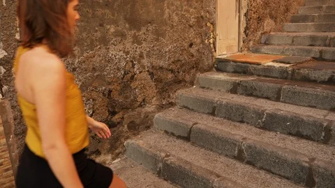 Brown-Haired Model Walking up the Stairs and Sits with Legs Crossed Stock Footage 115845404