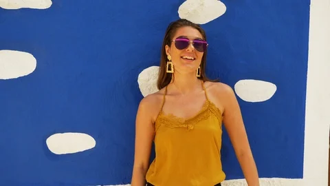 Brown-Haired Model Wearing Aviator Sunglasses with Back Against Wall Video stock 115845738