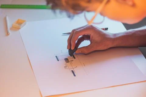 Brown-haired young architect creates new product designs for a new futuristic Stock Photos