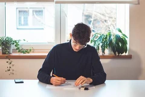 Brown-haired young architect creates new product designs for a new futuristic Stock Photos