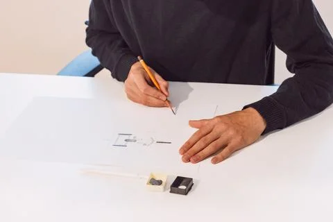 Brown-haired young architect creates new product designs for a new futuristic Stock Photos
