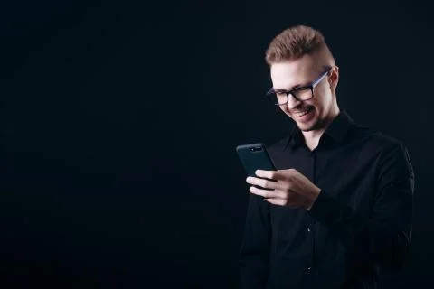 A Brown-haired Young Man Texting via Smartphone Stock Photos
