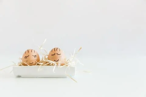 Brown hand drawn eggs with faces in the nest. Easter, Holiday concept, gift.. Stock Photos