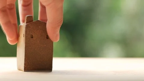 Brown home model made from clay, put down on wooden surface Stock-Footage 80903328