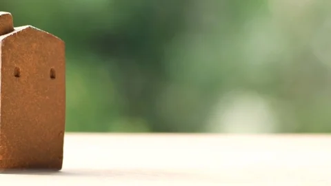 Brown home model on wooden surface, pan from left to right Stock Footage 80902673