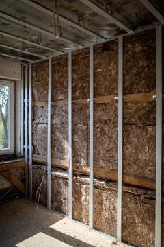 Brown Insulation wool was installed behind a drywall Stock Photos