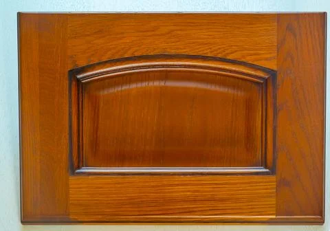 Brown kitchen facade close-up. background of natural wooden decorative item Stock Photos