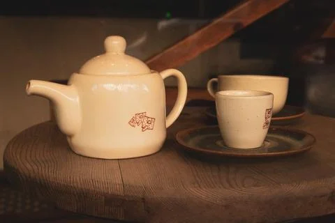 Brown kitchen mock up design. Tableware set. Ceramic beige teapot and two cups Stock Photos