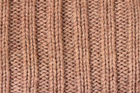 Brown knitted wool fabric texture. Ribbed textile background with yarn loop.. Stock Photos