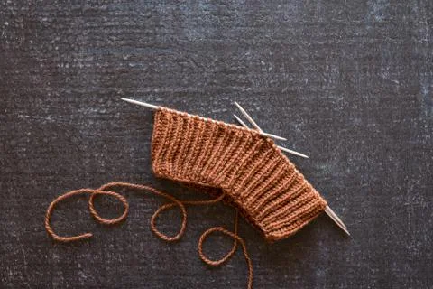 Brown knitting on black background Stock Photos