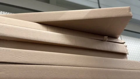 Brown kraft paper boxes arranged in stacked rows on a retail display for Stock Footage 345178112
