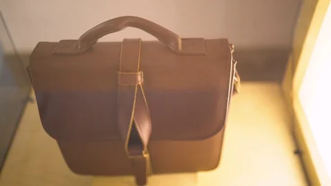 Brown Leather Bag in Display Case Stock Footage 104816680