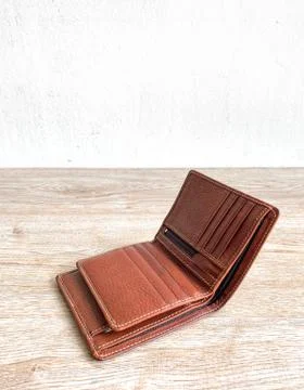 Brown leather luxury wallet put on wooden Stock Photos