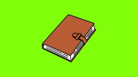 Brown leather notebook closing on green background. Stock Footage 340167079