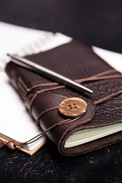 Brown leather notebook with wooden button and pen Stock Photos