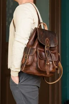 Brown leather oldfashioned backpack on a mans back Stock Photos