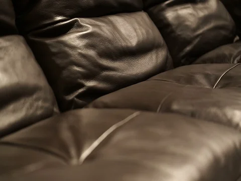 Brown leather sofa seats close up shot detail and texture Stock Footage 76543346