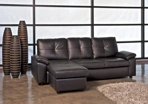 Brown leather sofa with stool Stock Photos