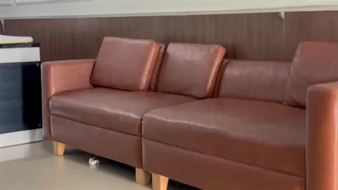 Brown leather sofa in a waiting room or living room 스톡 동영상 340485786