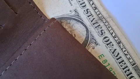 Brown leather wallet sliding open showing paper currency motion video Stock Footage 339302175