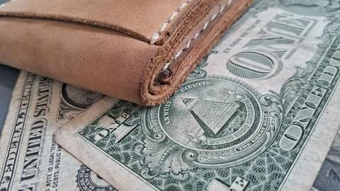 Brown leather wallet with US dollar bills. Cash money savings and personal Stock Photos