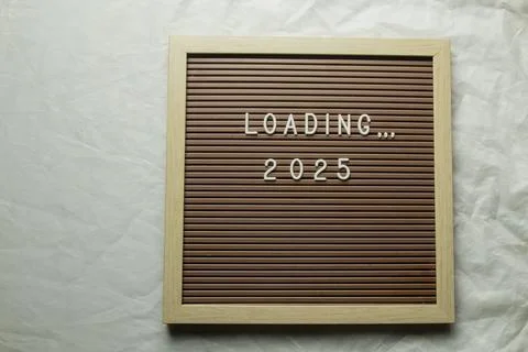 Brown letter board with message Loading 2025. Stock Photos
