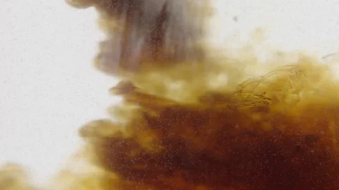 Brown liquid in water on a white background. Stock Footage 236822520