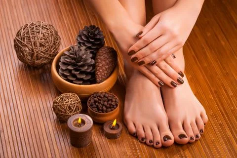 Brown manicure and pedicure on the bamboo Stock Photos